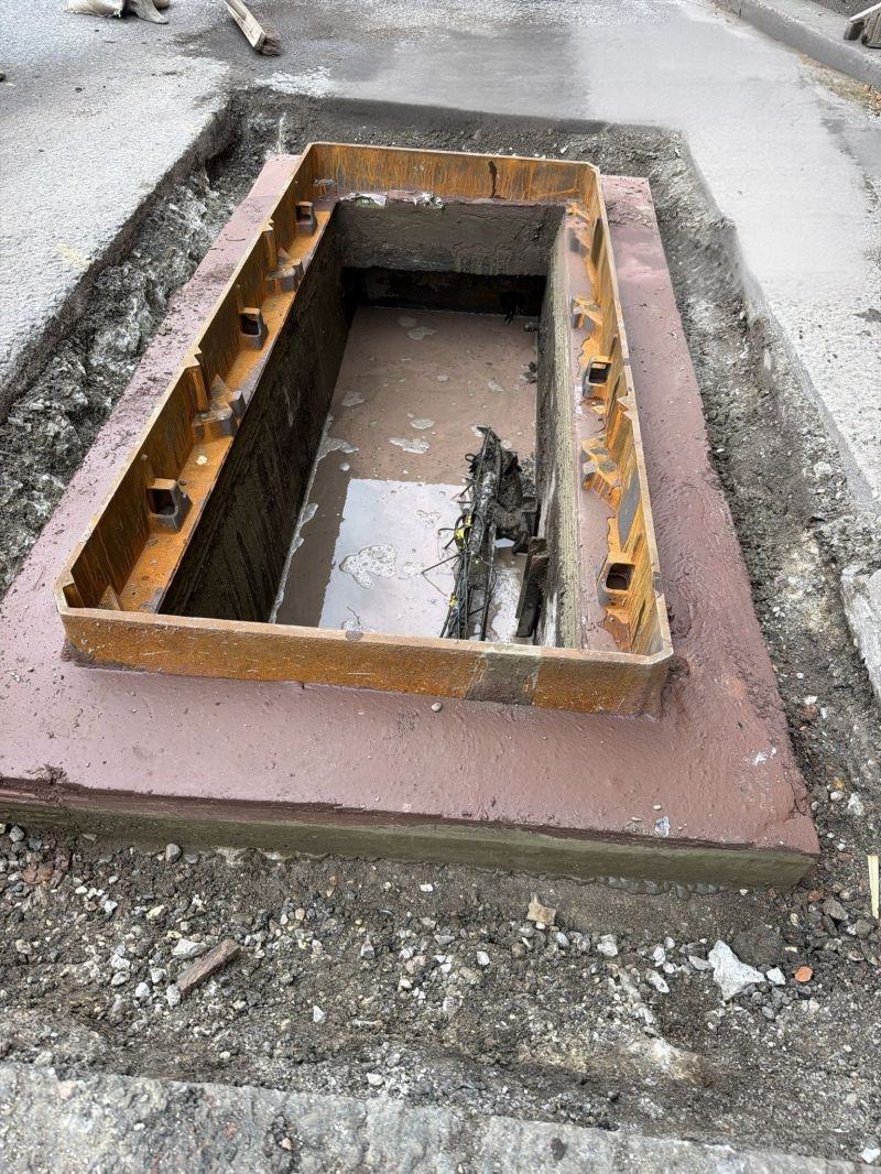 Chamber being built in the footway