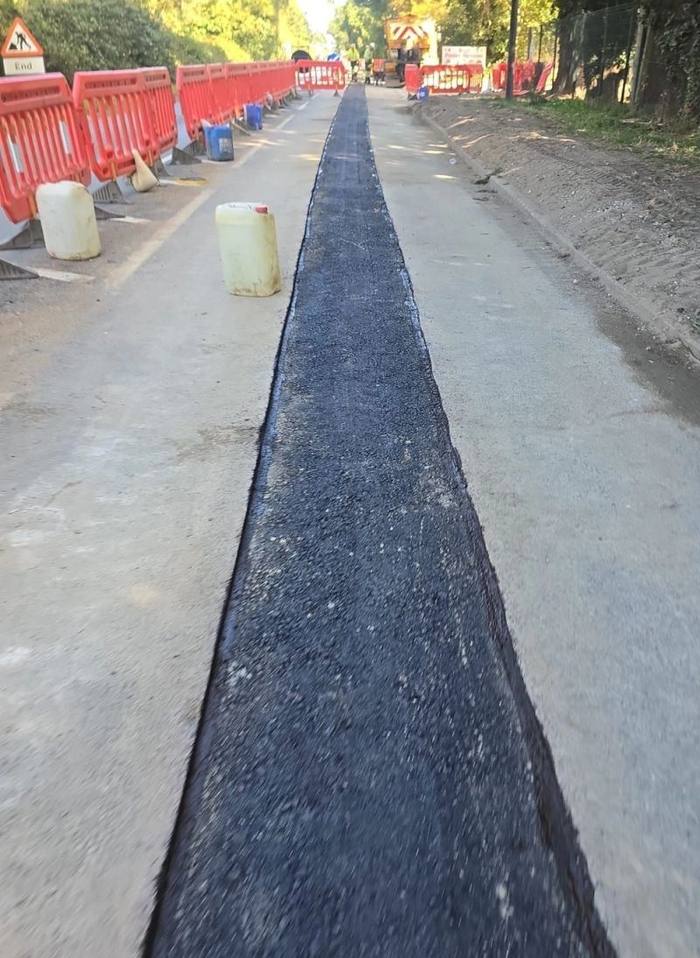 Reinstated trench running along a carriageway